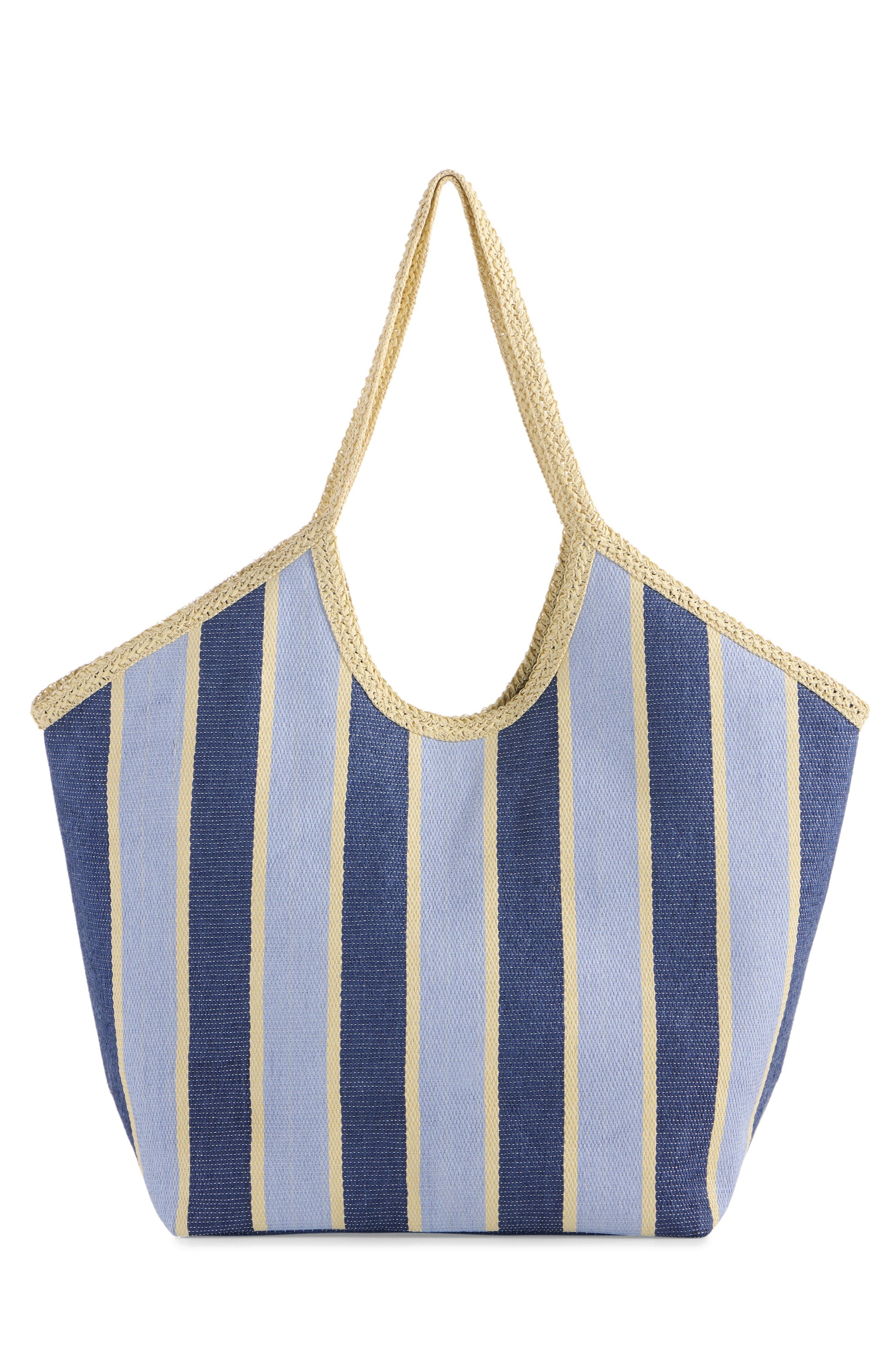 The South Moon Under Capri Tote is a spacious beach bag with wide vertical stripes in light blue, navy blue, and beige, finished with beige woven handles and trim.
