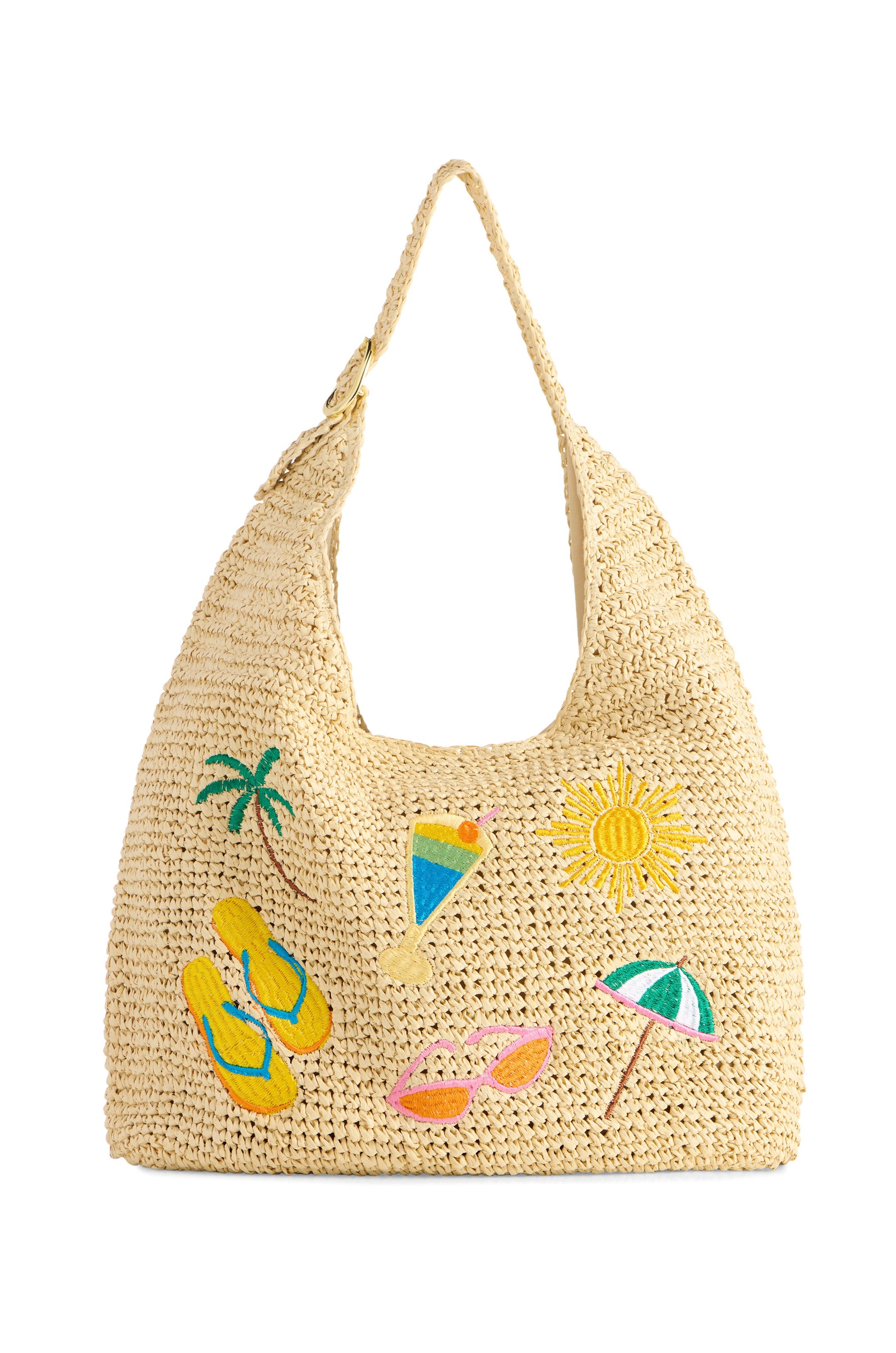 The South Moon Under Cabana Slouchy Tote is a beige woven straw bag featuring colorful embroidered palm tree, sun, cocktail, flip-flops, and beach umbrella designs on the front and a wide shoulder strap for tropical style.