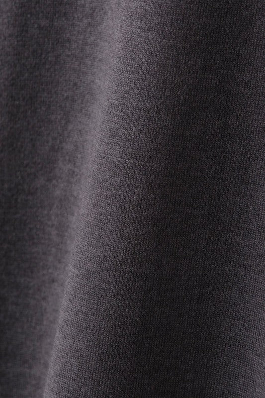 Close-up of the Atmosphere Tee by South Moon Under, featuring dark gray performance fabric with a soft, smooth texture and subtle diagonal shadow that highlights the material’s weave and drape.