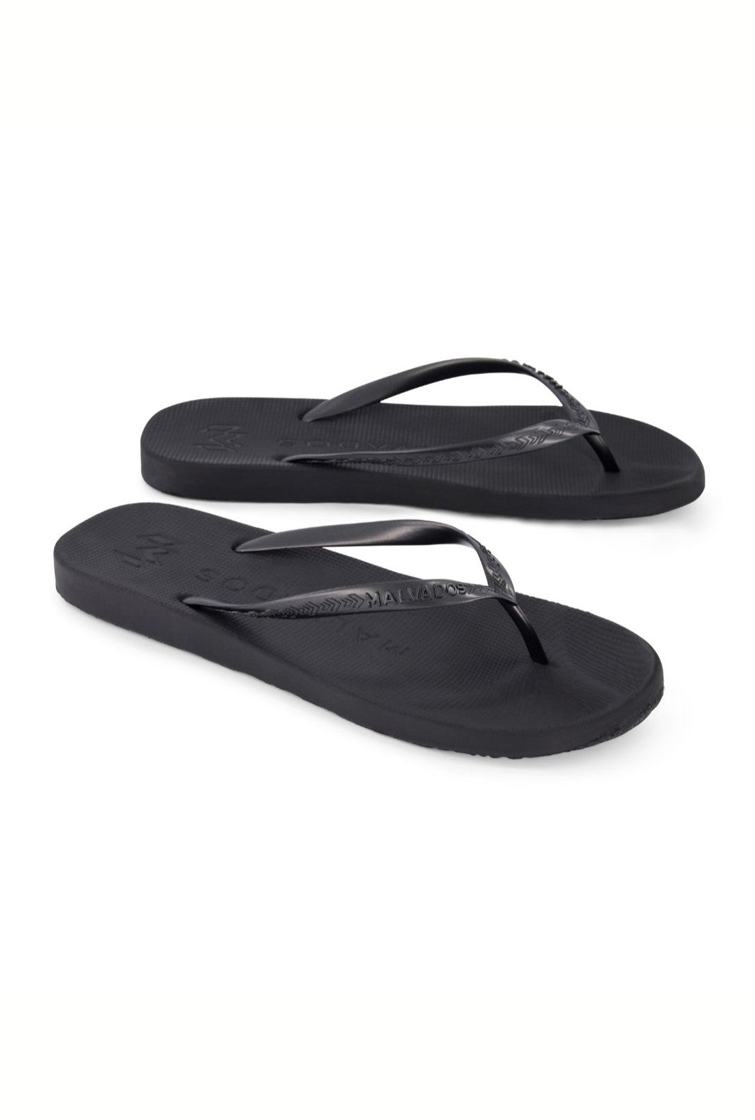 The Malvados Playa Onyx Flip Flop features a simple black design with thin straps and a contoured footbed for comfort, shown against a white background.