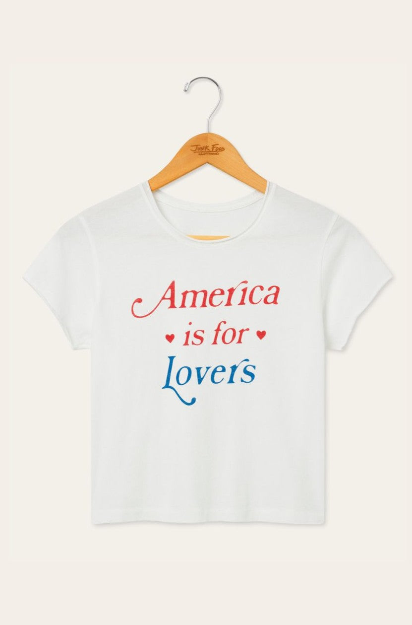 The Original Retro Brand America Is For Lovers classic white short-sleeve crew neck t-shirt hangs on a wooden hanger, showcasing red and blue lettering with small red heart accents.