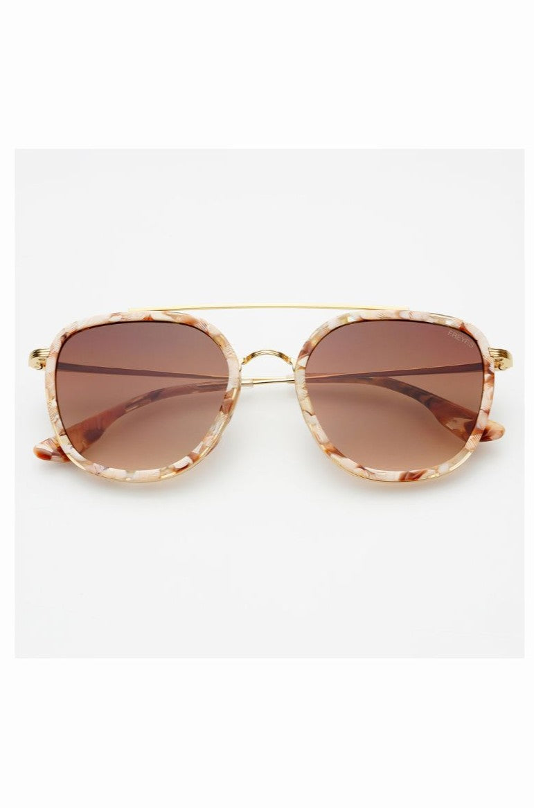 Freyrs Weston Sunnies are unisex sunglasses featuring rose gold metal frames, brown gradient lenses, and marbled pink and beige biodegradable acetate rims, offering stylish UV protection.