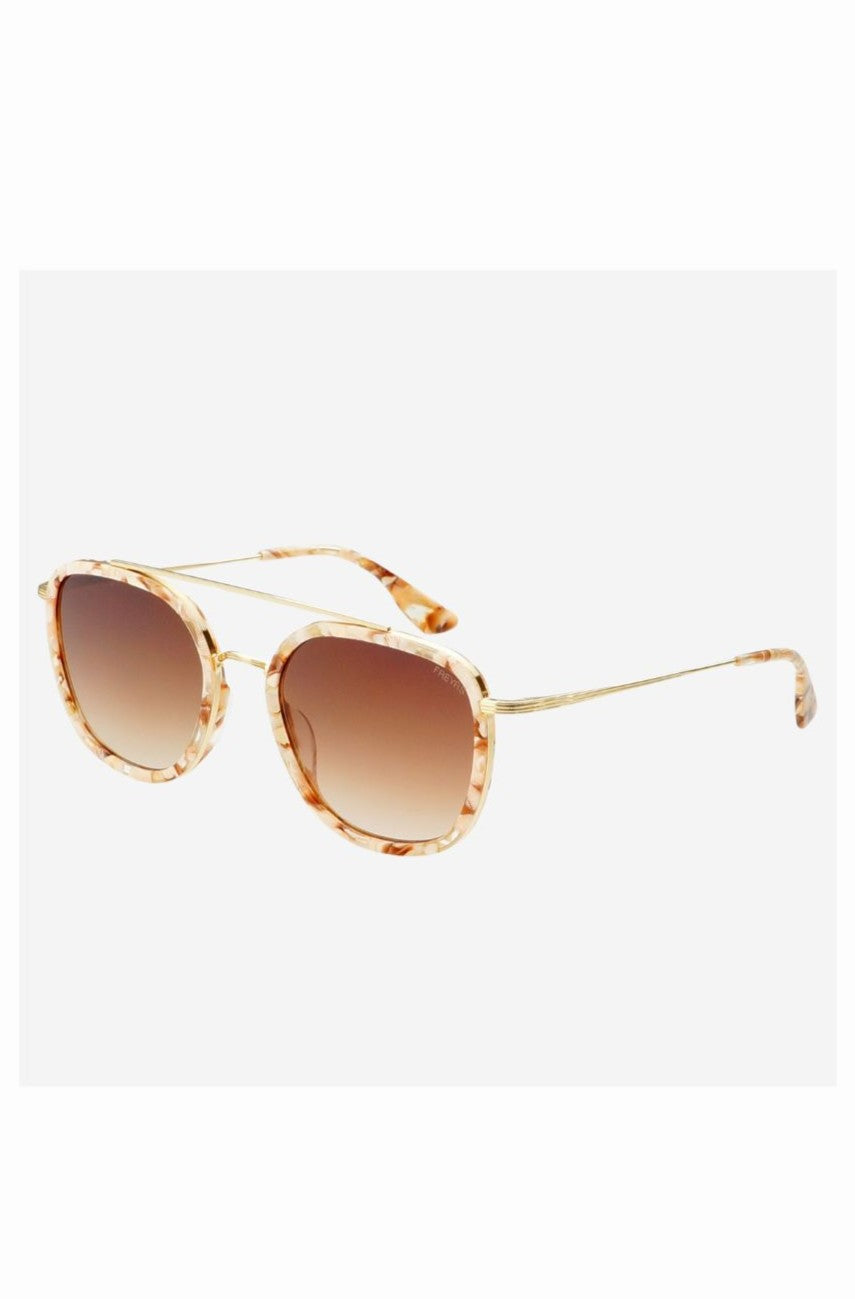 The Freyrs Weston Sunnies are beige and gold round unisex sunglasses with brown gradient lenses, a marbled frame pattern, thin curved arms, and are made from biodegradable acetate for UV protection.