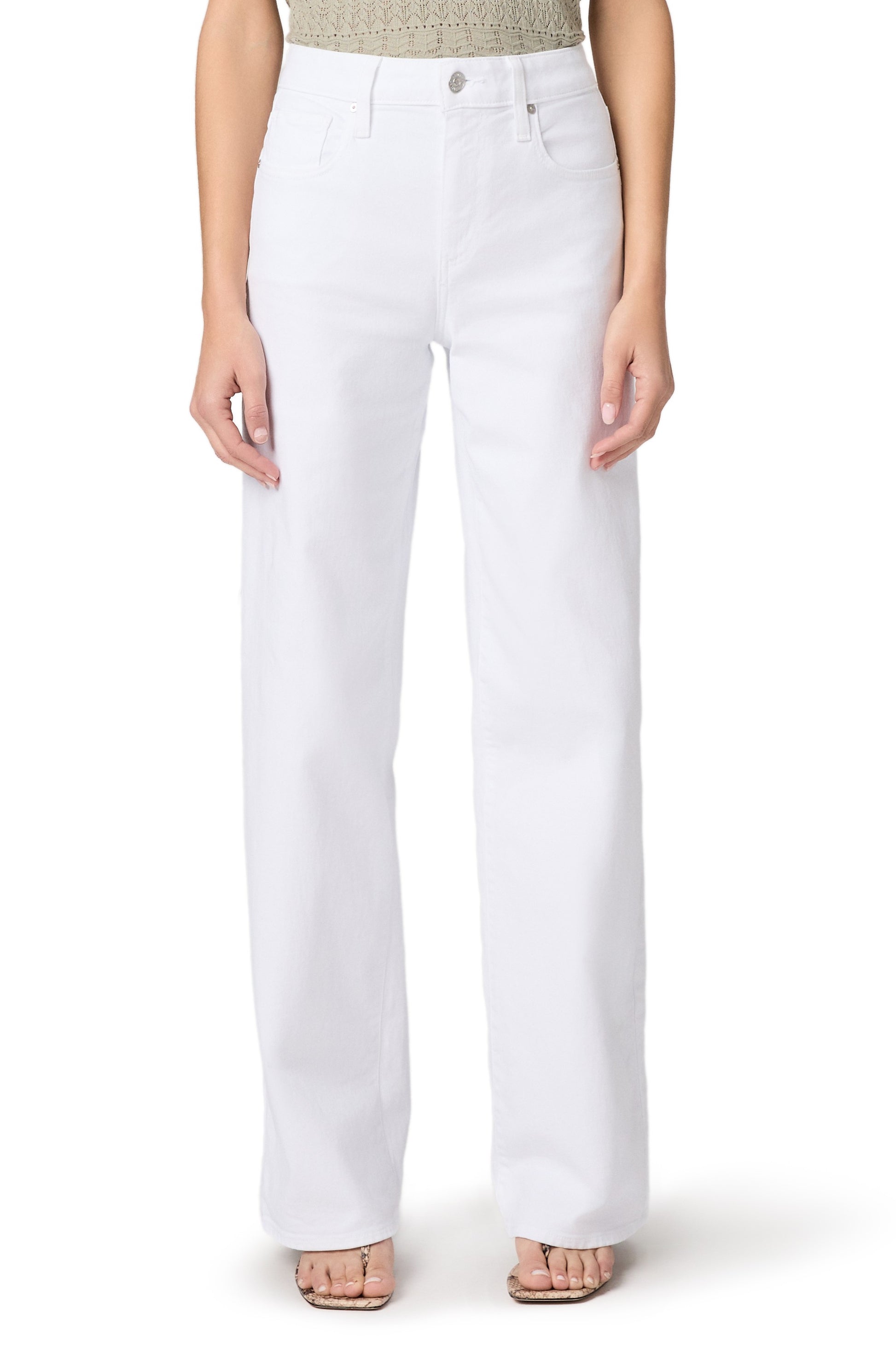 A person wearing Paige Tatum 32 In Crisp White relaxed-fit, high-waisted jeans in white comfort stretch denim and open-toed sandals, standing with arms relaxed by their sides; only the body from shoulders down is visible.