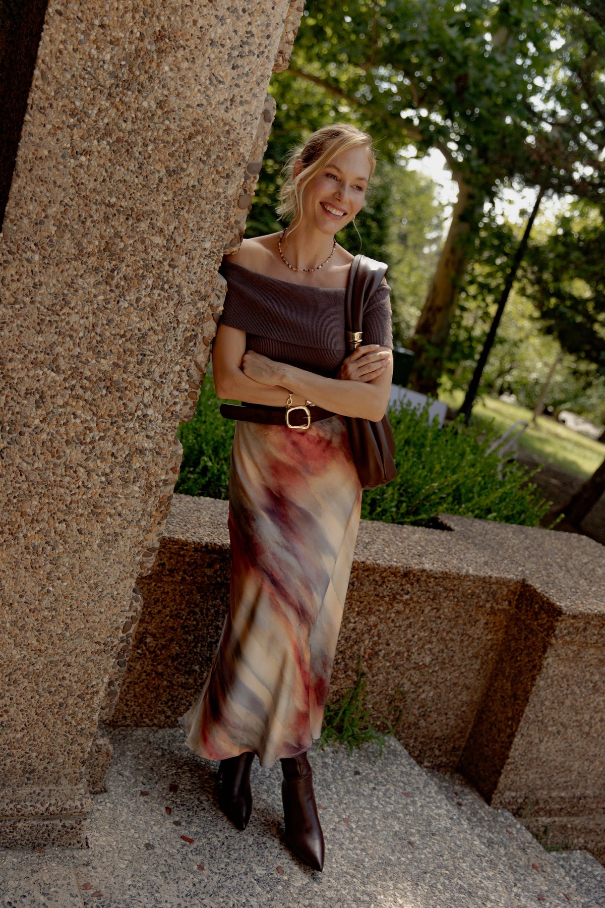 Cream and burgundy watercolor-print satin skirt with midi length, worn with brown off-shoulder top.