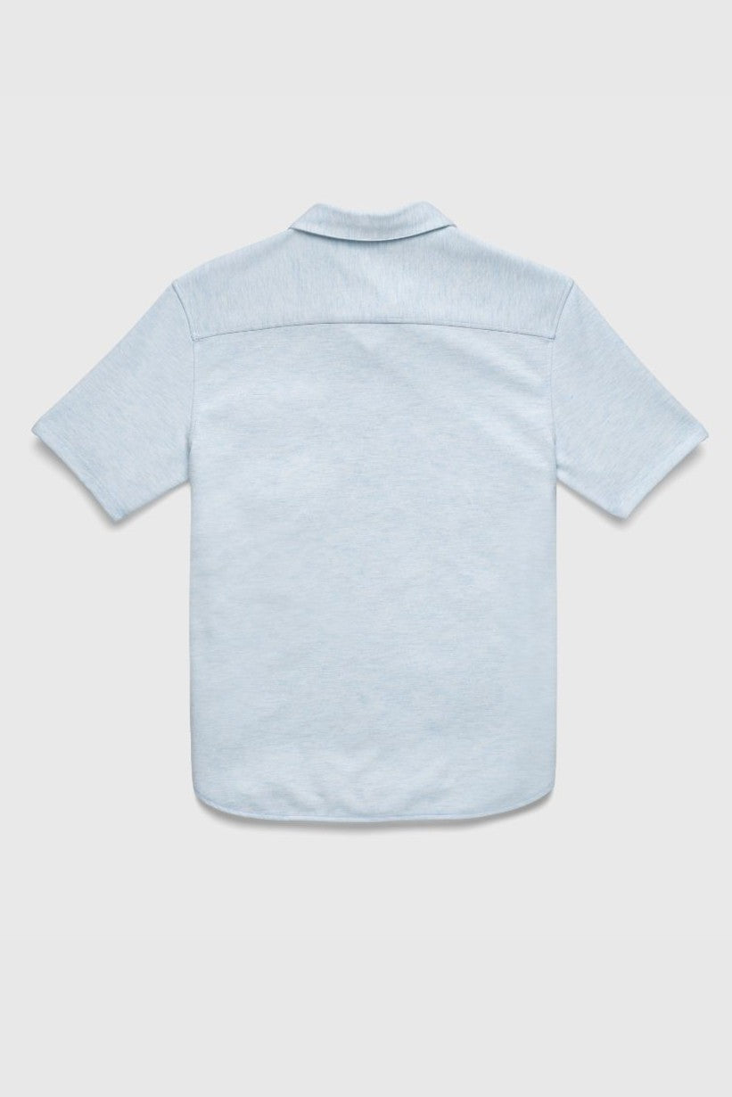 The Tony Short Sleeve Burnout Knit Shirt by Surfside Supply Co. is displayed from the back, laid flat on a light gray surface. This light blue shirt has a regular fit, soft collar, short sleeves, and no visible logos or patterns.