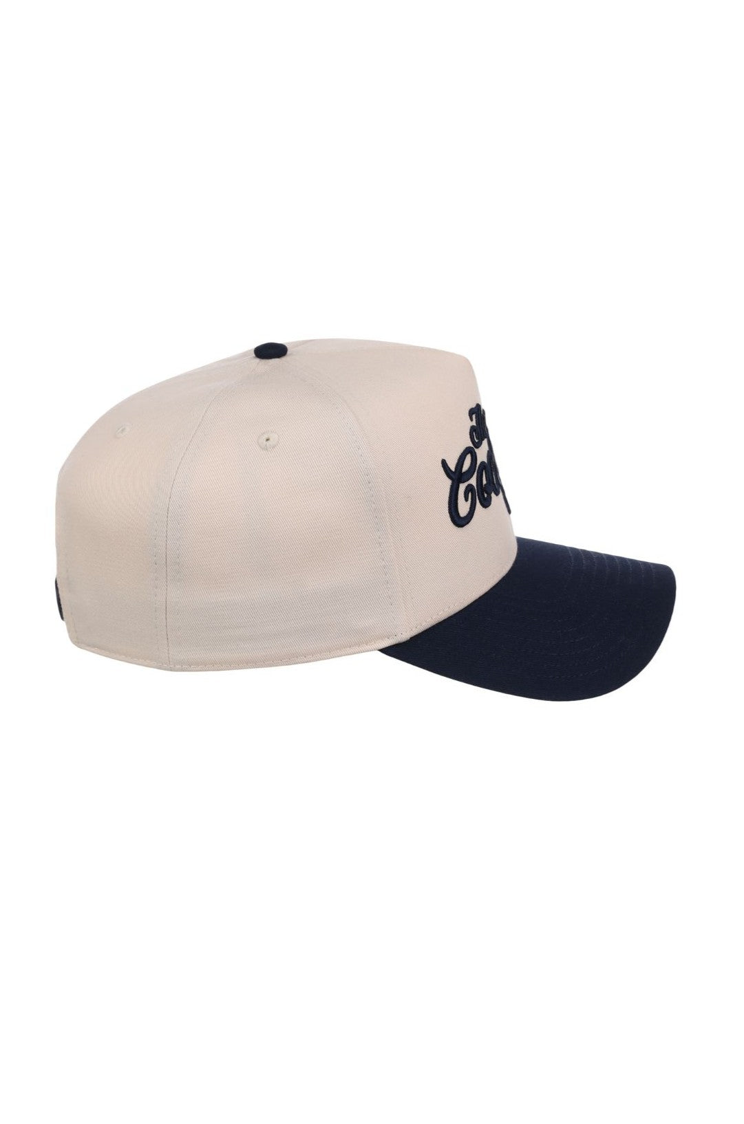 The South Moon Under Smu Cocktail Club 5-panel Hat is a beige baseball cap featuring a black curved brim and black embroidered text on the front, designed with a low crown and displayed in side profile against a white background.