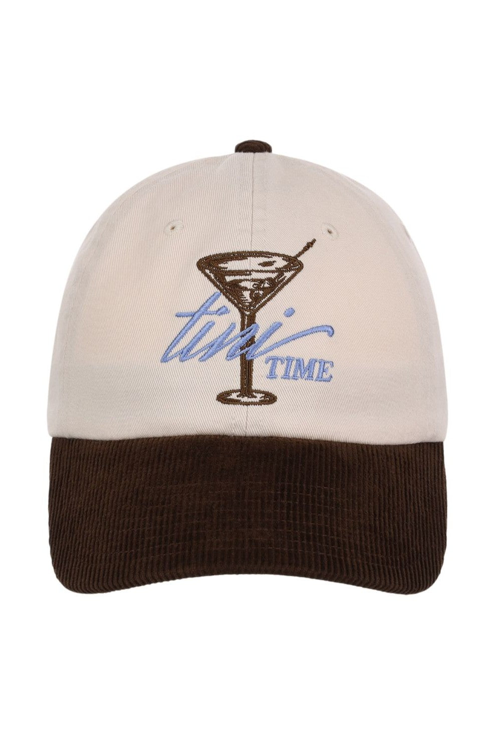 The South Moon Under Smu Tini Time Cap is an ivory and brown baseball cap with a flat bill, low crown, and adjustable snapback closure. It features an embroidered martini glass, the word "tini" in script, and "TIME" in block letters on the front.