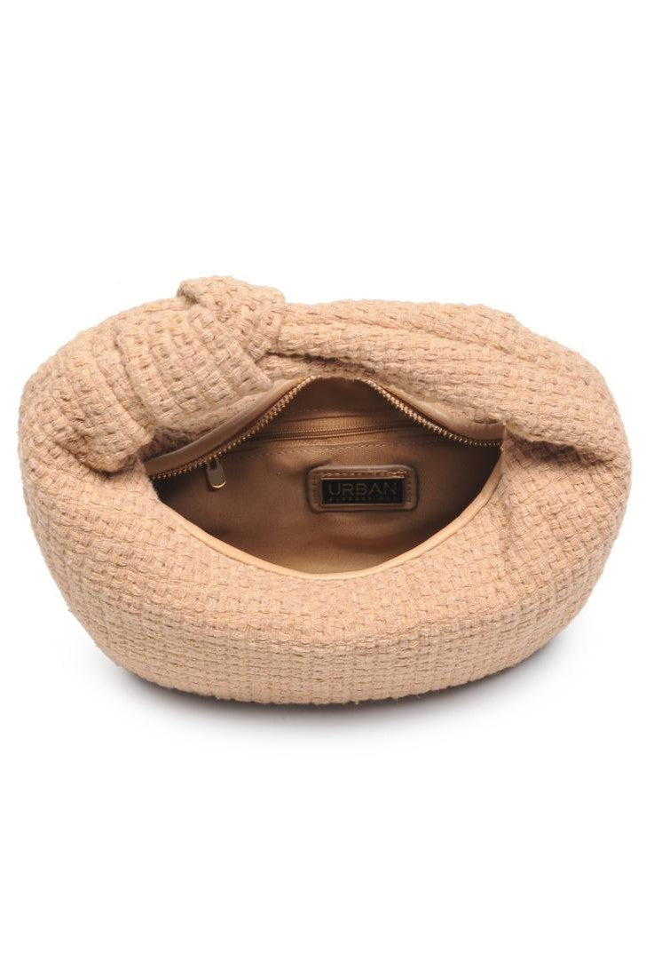The Tracy Bag in Natural Tweed by Urban Expressions is a tan woven handbag shown from above, with a soft, textured crescent shape, open top, and an interior zip pocket featuring the Urban Expressions label.