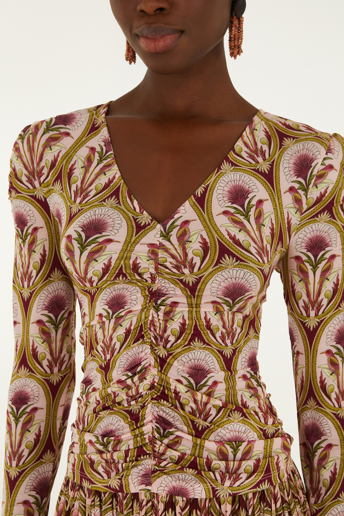 Long sleeve blouse with multicolor floral print in burgundy, gold, and cream featuring fan-shaped flowers and ornamental vine