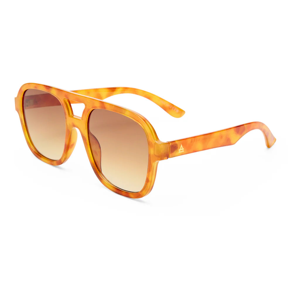 The Aire Whirlpool Sunnies feature a yellow-orange vintage tort square frame and brown gradient lenses, displayed at a three-quarter angle on a white background.