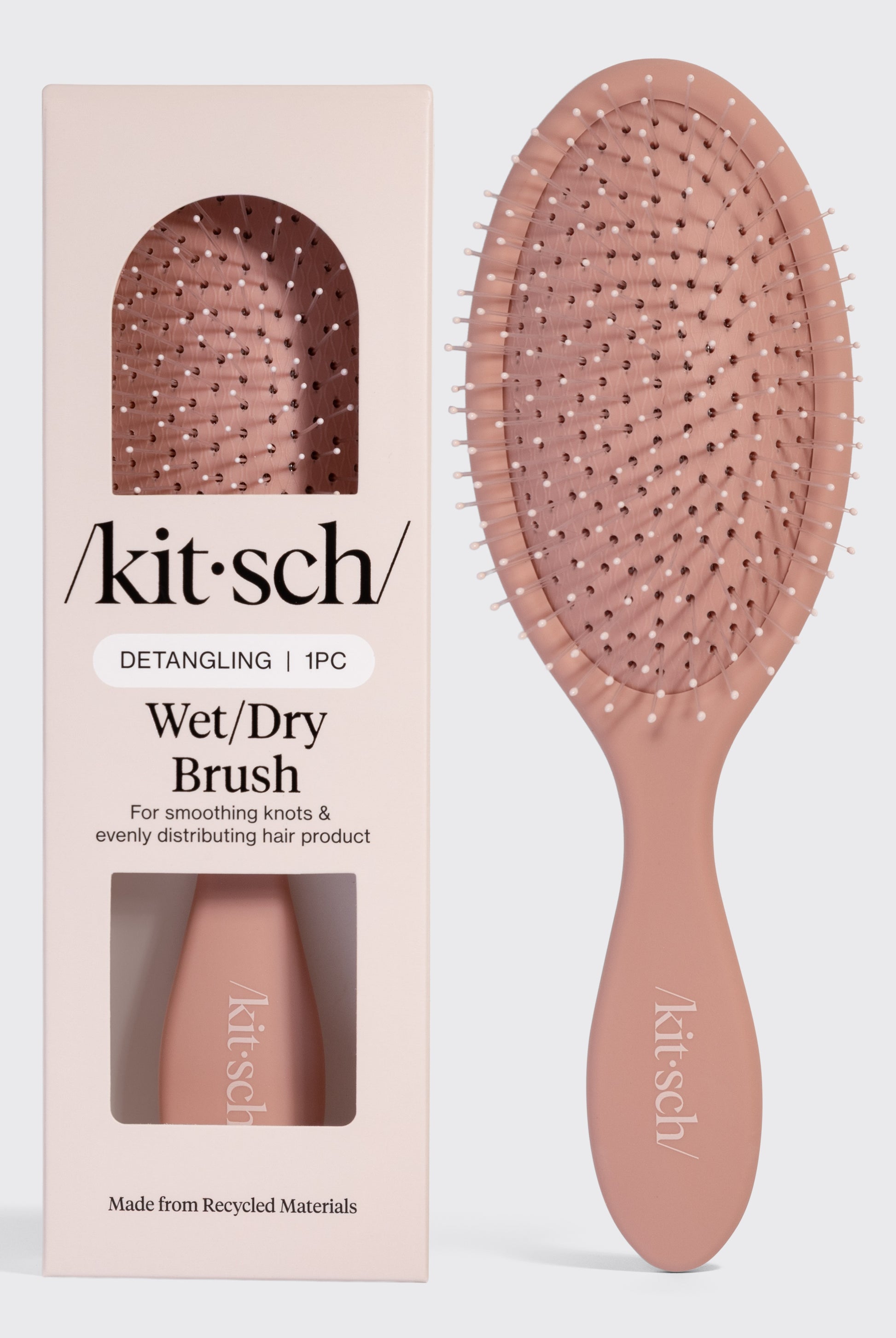 A taupe Kitsch Wet/dry Brush for all hair types is shown beside its packaging, which has a cutout displaying the brush and text highlighting its use for smoothing knots and distributing hair product.