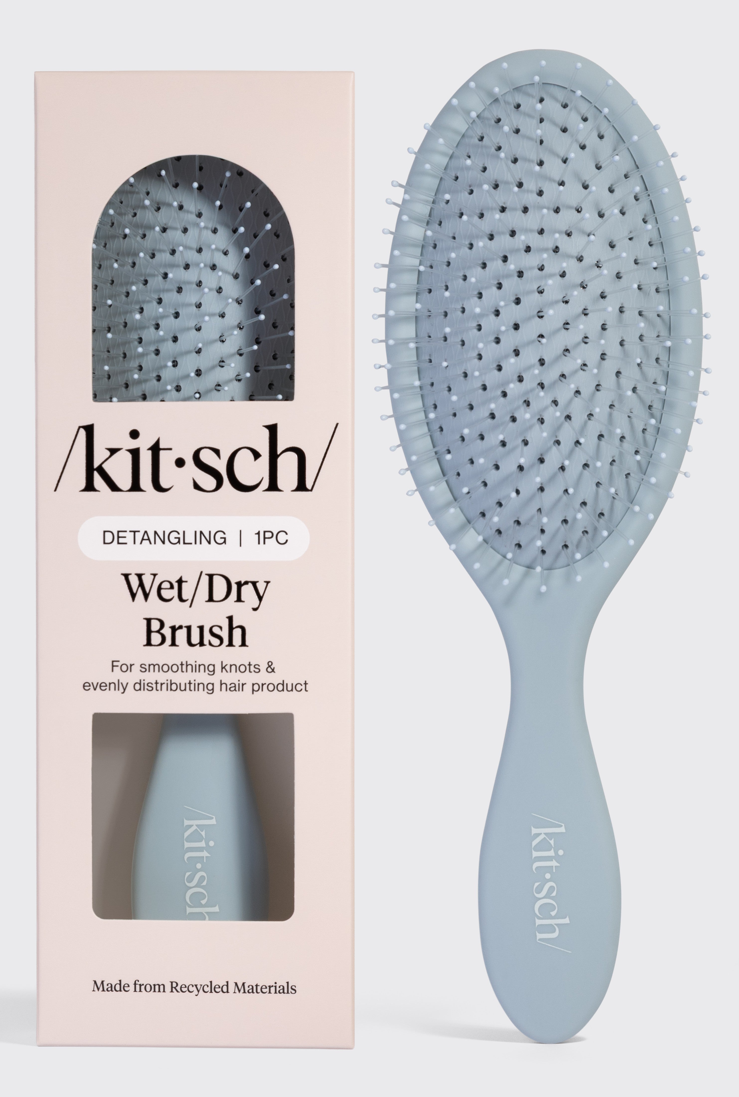A blue Kitsch Wet/Dry Brush is shown inside its packaging and next to the box, which reads: Detangling Wet/Dry Brush—for all hair types, smoothing knots, frizz-free hair, and evenly distributing product.
