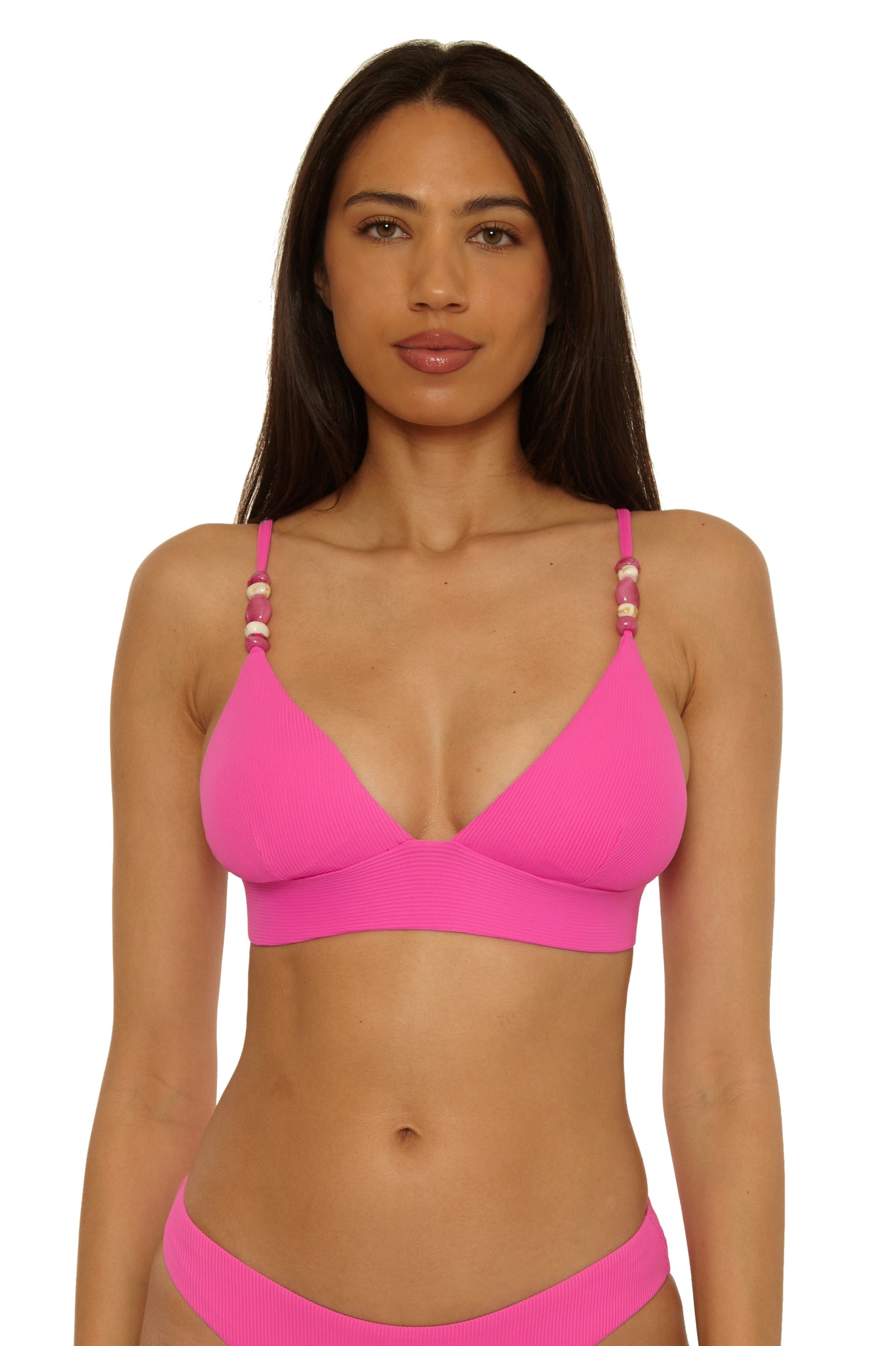 A woman models the Becca Swim Modern Edge Halter in ROSE BERRY, a bright pink bikini with beaded, adjustable straps. She stands against a plain white background, looking directly at the camera with a neutral expression.