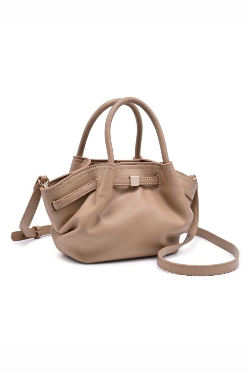 The Selena Mini Crossbody by Urban Expressions is a small beige handbag with two short handles and an adjustable strap, crafted from smooth leather and shown against a white background.