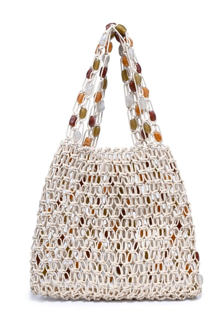 The Asher Beaded Beach Bag by Urban Expressions features a cream woven macramé design with colorful oval beads on the handles and sides, shown against a white background.