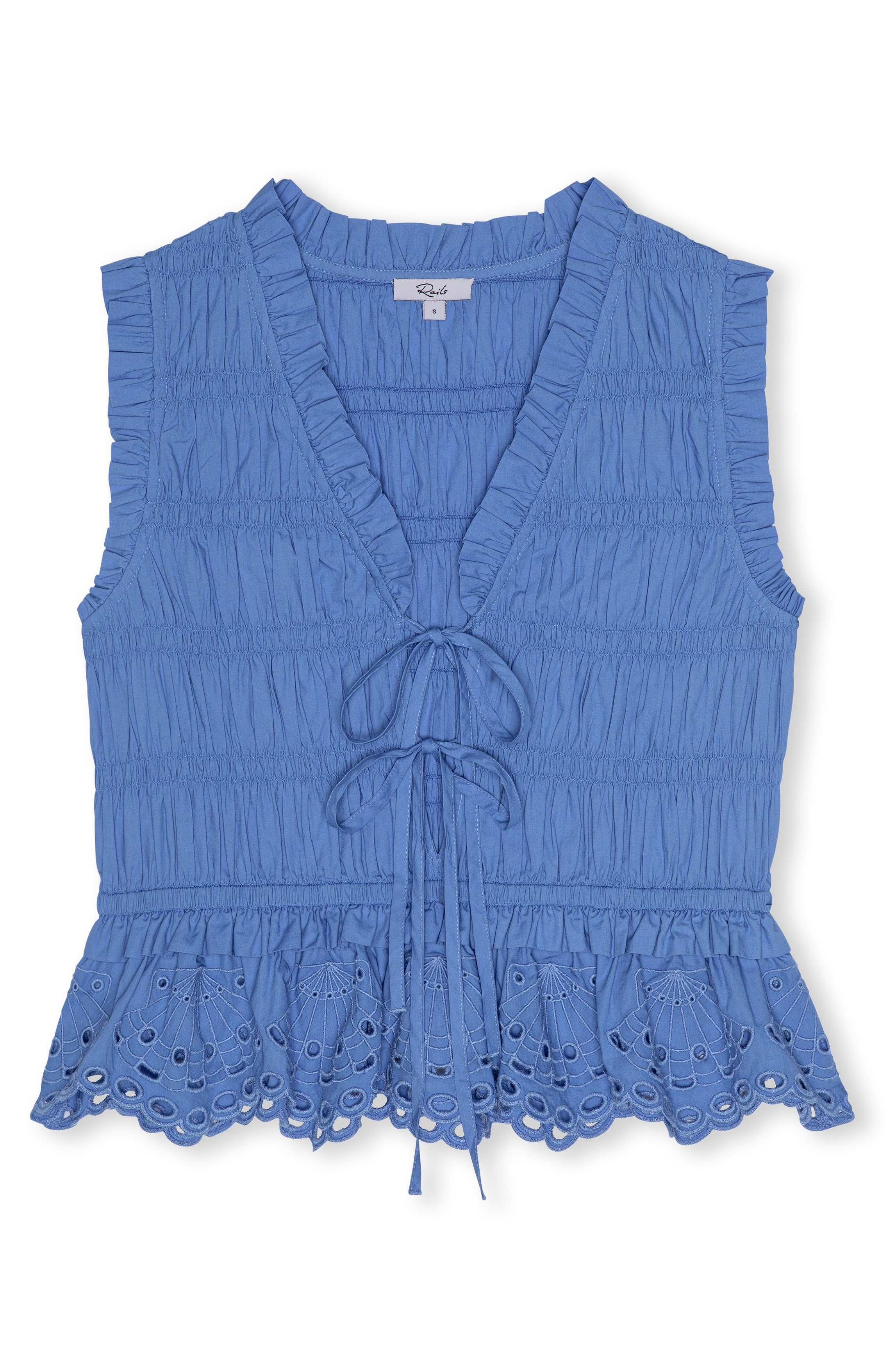 The Martine Sleeveless Top by Rails features a blue cotton poplin fabric, ruffled V-neck with tie-front, eyelet lace hem, and a flattering peplum silhouette.