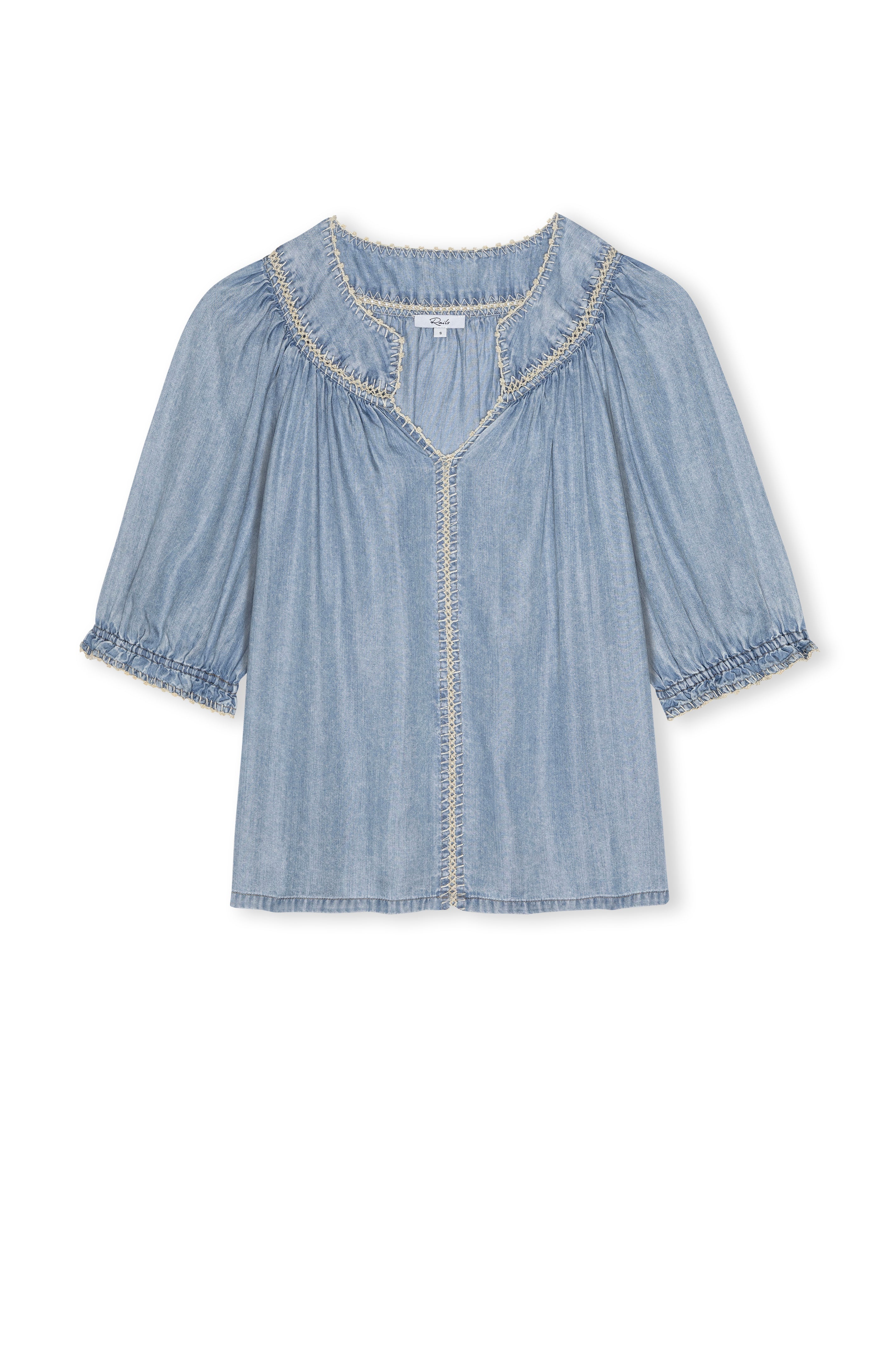 The Belina Short Sleeve Denim Top by Rails is crafted from light blue ultra-soft TENCEL, featuring ruffled trim on the collar, sleeves, and front with a loose fit and gathered neckline and sleeves for effortless charm.