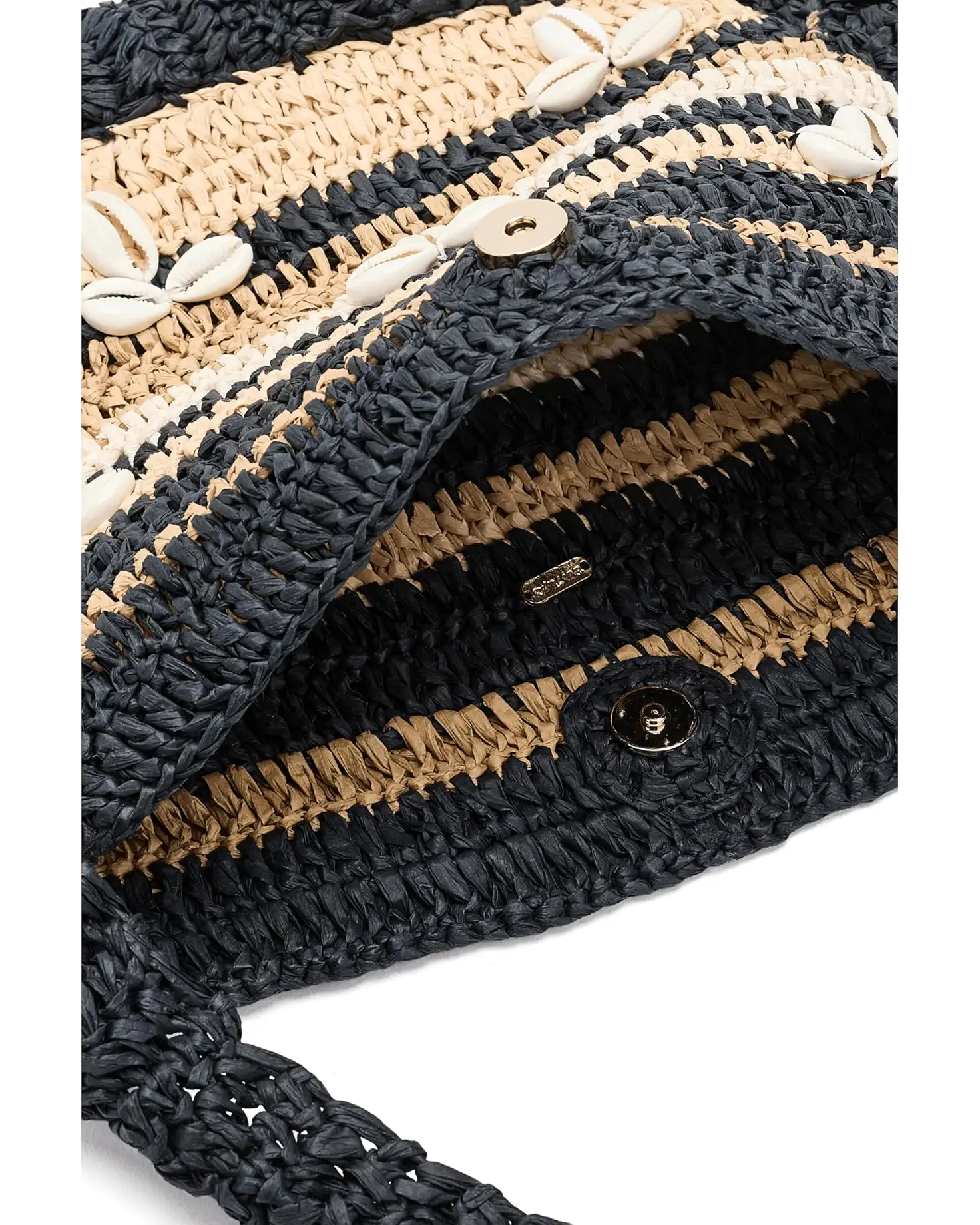 Close-up of the Free People Belize Shell Clutch, a woven straw bag with navy and beige stripes, white cowrie shell accents, and a black button clasp—a stylish hobo beach accessory.