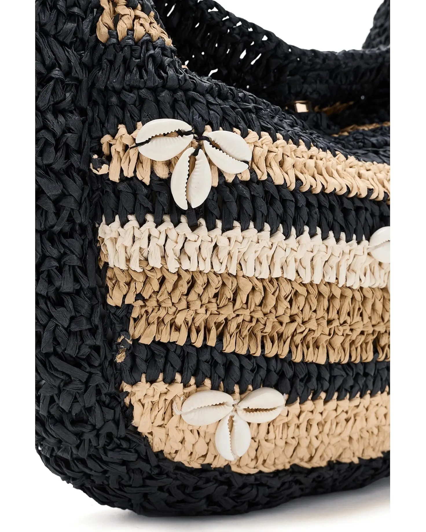 Close-up of the Belize Shell Clutch by Free People, featuring horizontal black and beige stripes and white cowrie shells arranged in floral patterns.