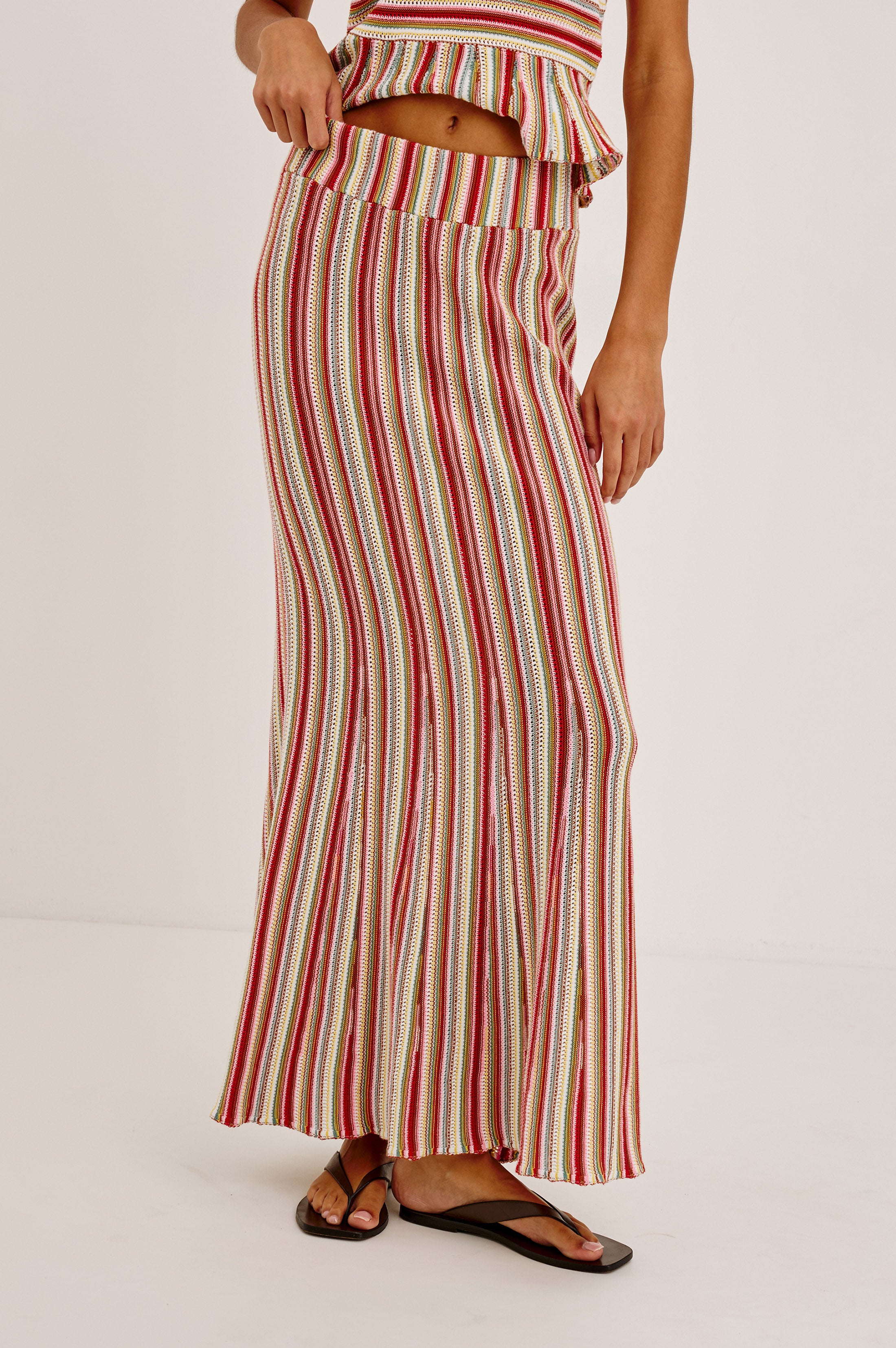 A person wearing the Rails Nari Skirt in Red Multi with a matching sleeveless top and black sandals, standing against a plain white background.