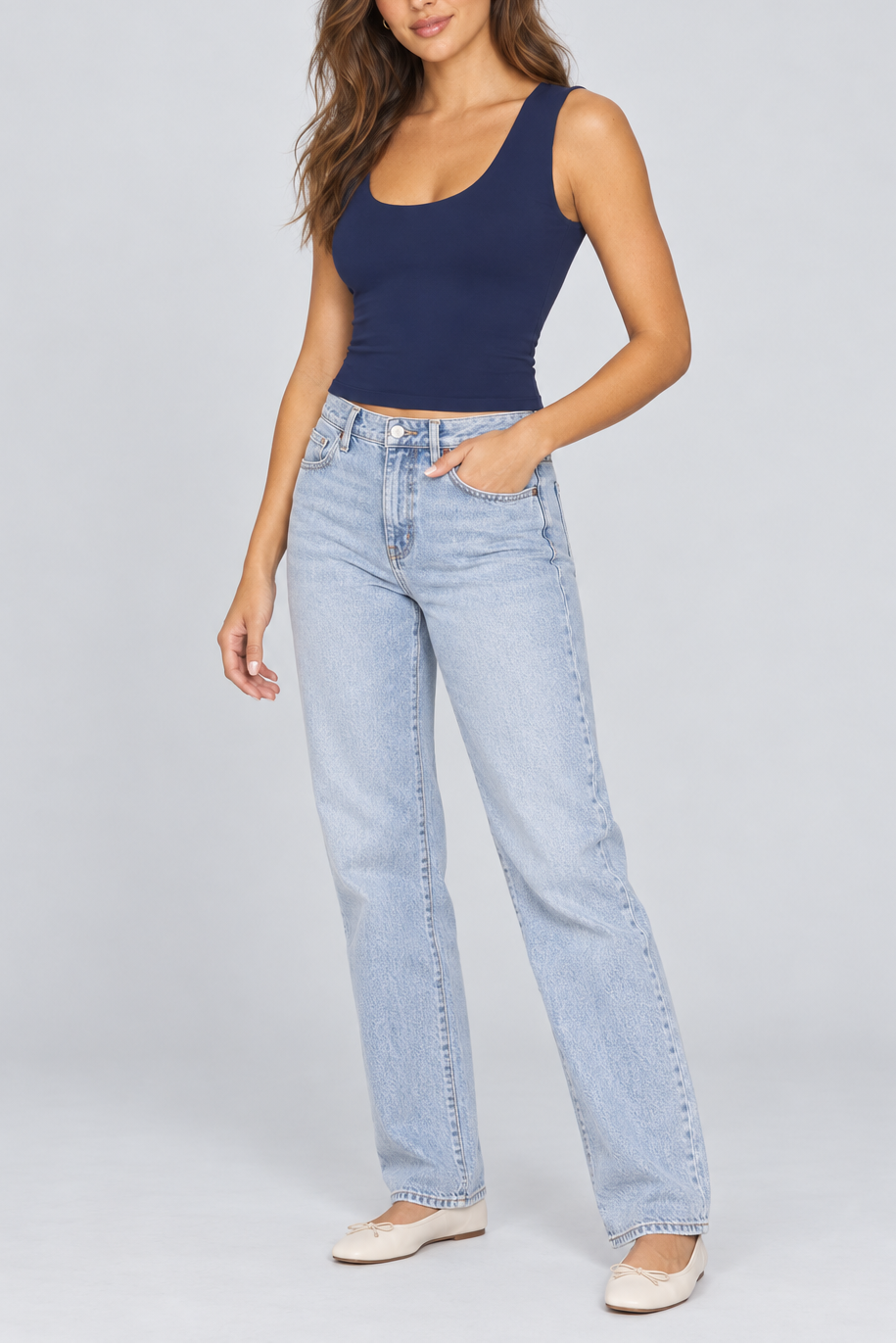 Sleeveless dark navy muscle cami with scoop neckline paired with light wash straight-leg jeans.