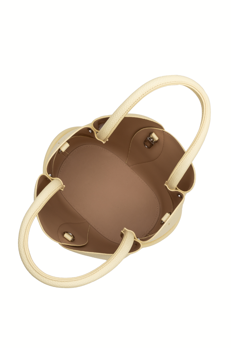 Top-down view of the Melie Bianco Tulip Purse in recycled vegan leather, beige exterior with brown interior, two handles, gold-tone hardware, and removable zip pouch, shown empty against a white background.