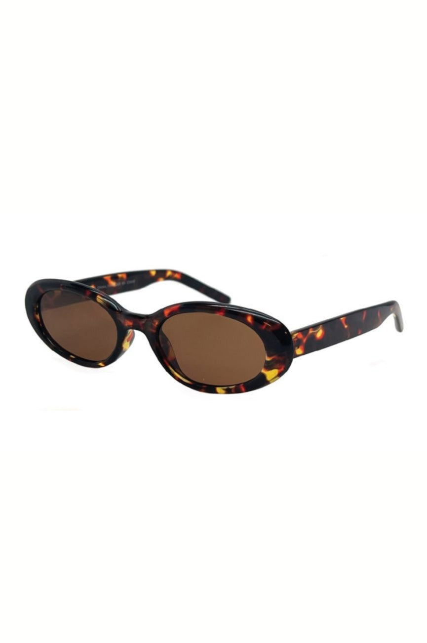 The Amelia Sunnies by South Moon Under feature oval frames in a brown multi tortoiseshell pattern, monotone lenses with 100% UV protection, and matching straight arms.