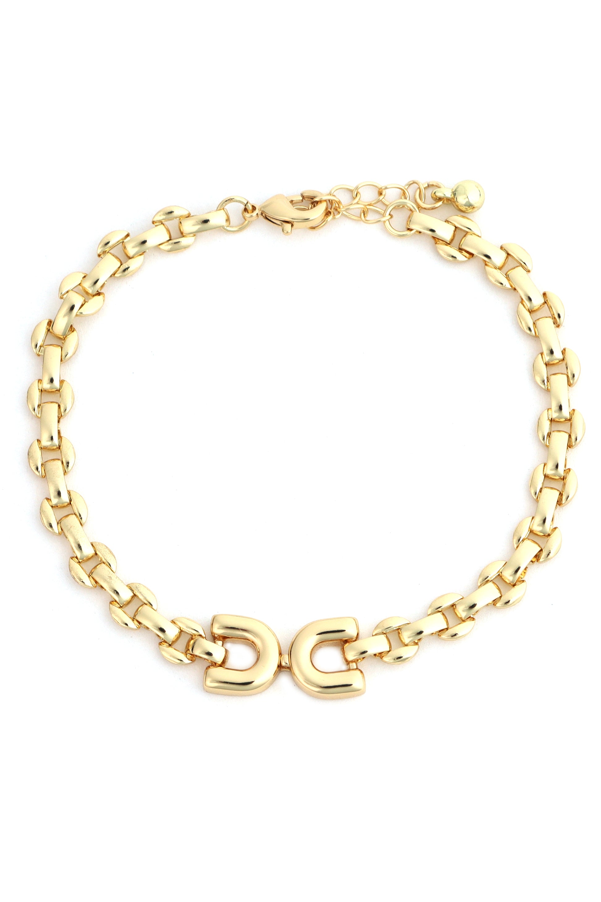 The South Moon Under Gold Horsebit Bracelet features interlocking oval links, a lobster clasp, and a double horseshoe centerpiece, all crafted in gold-plated brass. Color: Gold.