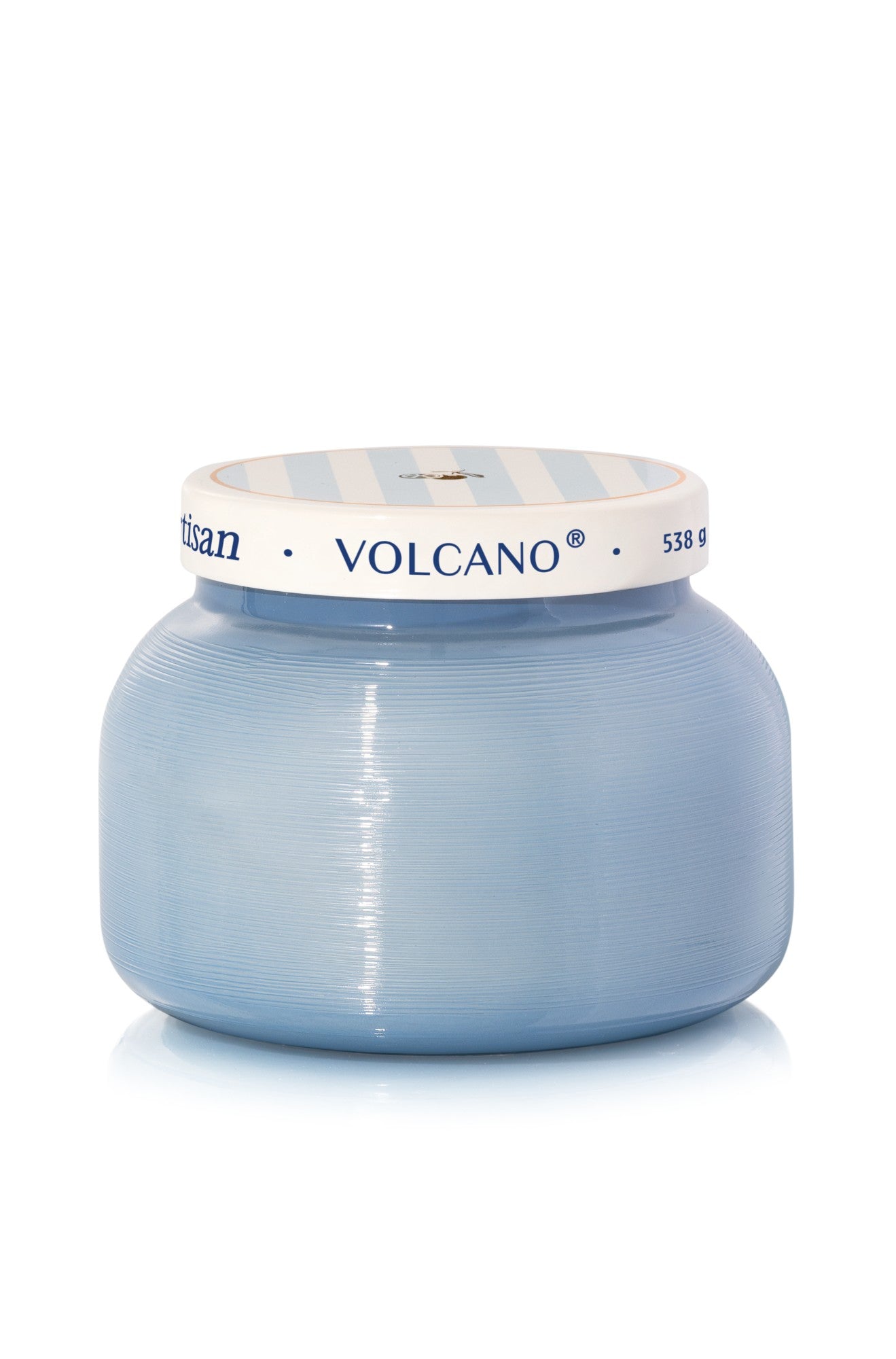 The Volcano Signature Candle by DPM Fragrance features a light blue, round ribbed glass jar with a matching striped lid and sugared citrus fragrance with tropical fruits. Weight: 538g.