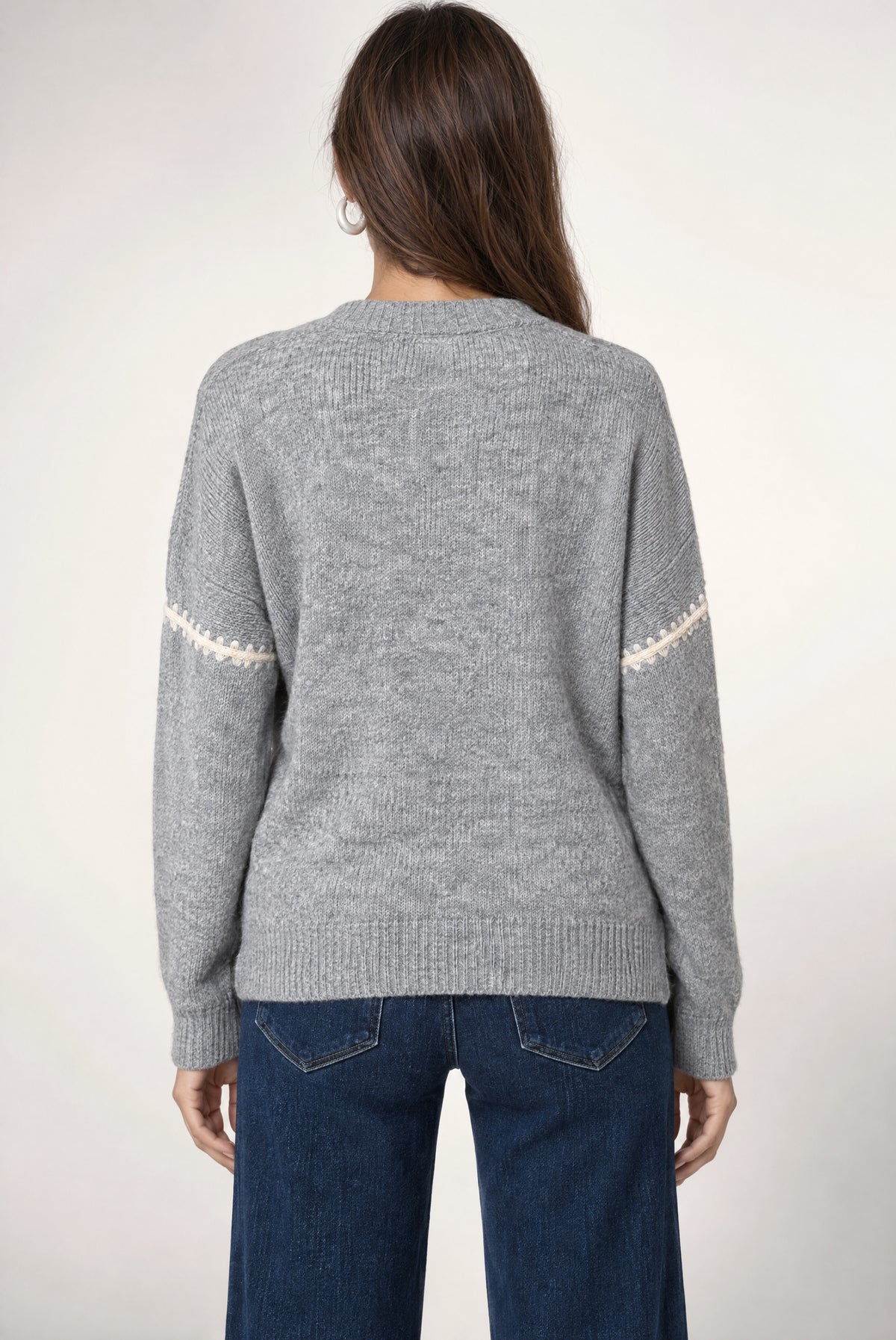 Heather grey ribbed sweater with ivory stripe details on sleeves, shown from back on model wearing dark jeans.