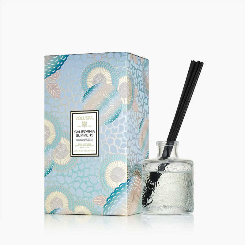 The Voluspa California Summers Large Diffuser (100ml) with black reeds is shown next to a decorative blue and gold box, both on a white background for a premium look.