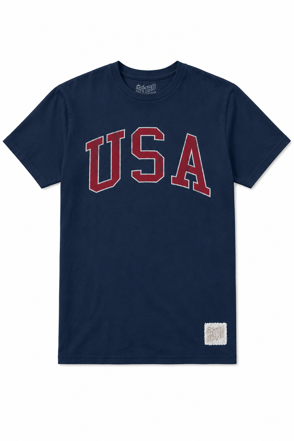 The USA Arch Tee by Original Retro Brand is a navy unisex t-shirt with bold red and white “USA” text on the chest and a rectangular patch near the lower left hem, blending ultra-soft vintage comfort with classic style.