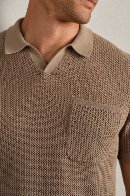 A man wears the South Moon Under Coastal Johnny Collar Polo—a textured, short-sleeve, light brown knit with a chest pocket and contrasting collar—shown from shoulders to upper chest.