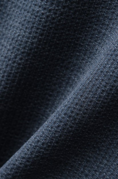Close-up of the Commuter Seersucker Short Sleeve Shirt by South Moon Under, featuring dark blue Italian seersucker fabric with a textured, waffle-like pattern and visible folds for depth and style.