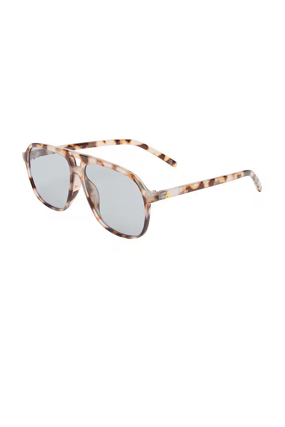 The Aire Aquarius Sunnies feature a cookie tort frame and shatterproof polycarbonate lenses in a smoke tint, shown angled on a white background.
