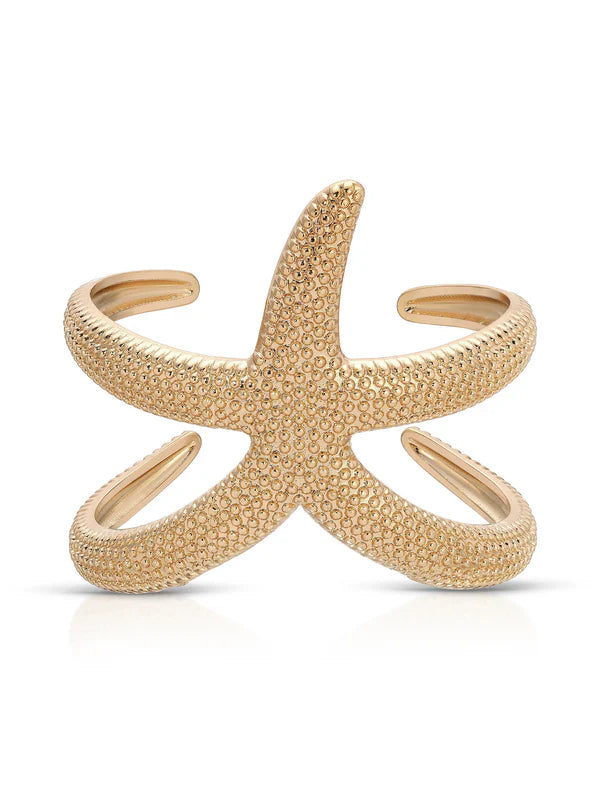 The Ettika Starfish Hug Cuff is a gold bangle bracelet shaped like a textured starfish with five curved arms and open sides, shown against a plain white background.