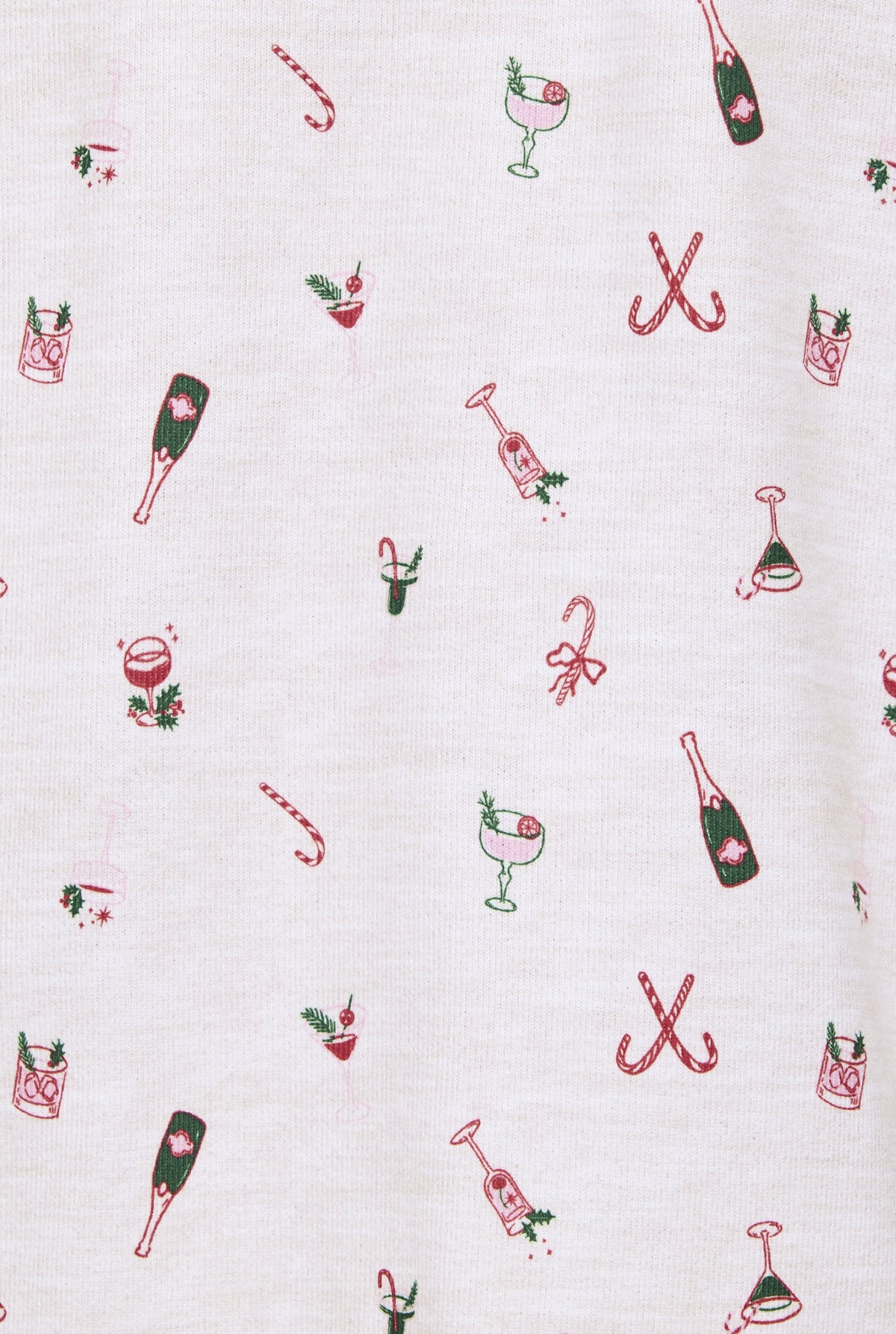 White jersey fabric with scattered red and green Christmas cocktail-themed embroidered motifs including champagne bottles, ca
