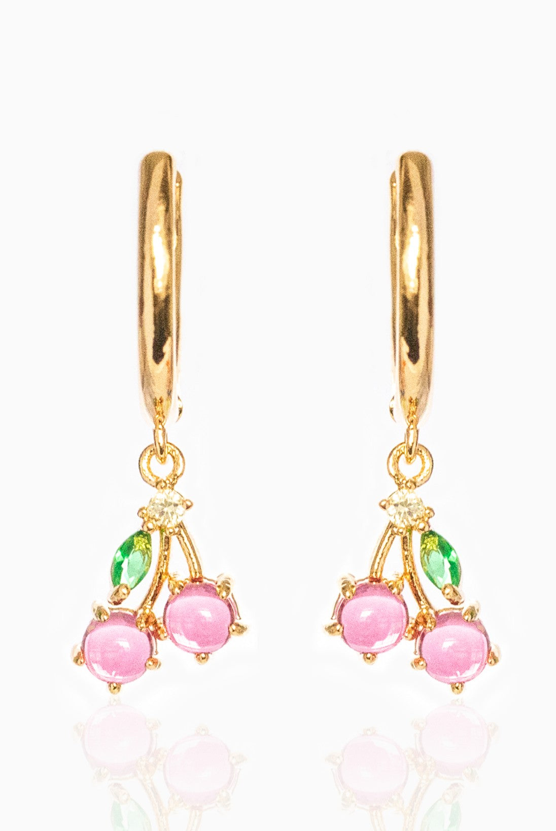 Girls Crew's Cherry Sweet Mini Hoops are 18k gold plated hoops with dangling cherry-shaped charms, pink bead fruit, green leaves, and cubic zirconia stones—shown on a white background.
