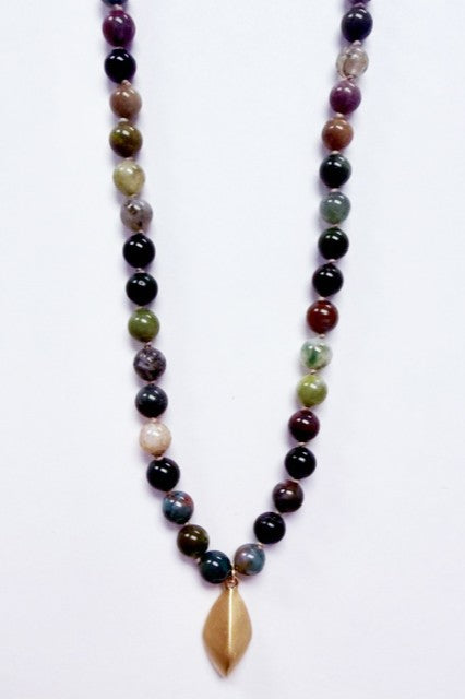 The Marlyn Schiff Multi Bead Pendant Necklace in Green Multi features round, multicolored beads and a gold leaf-shaped pendant—ideal for statement jewelry lovers, shown against a white background.