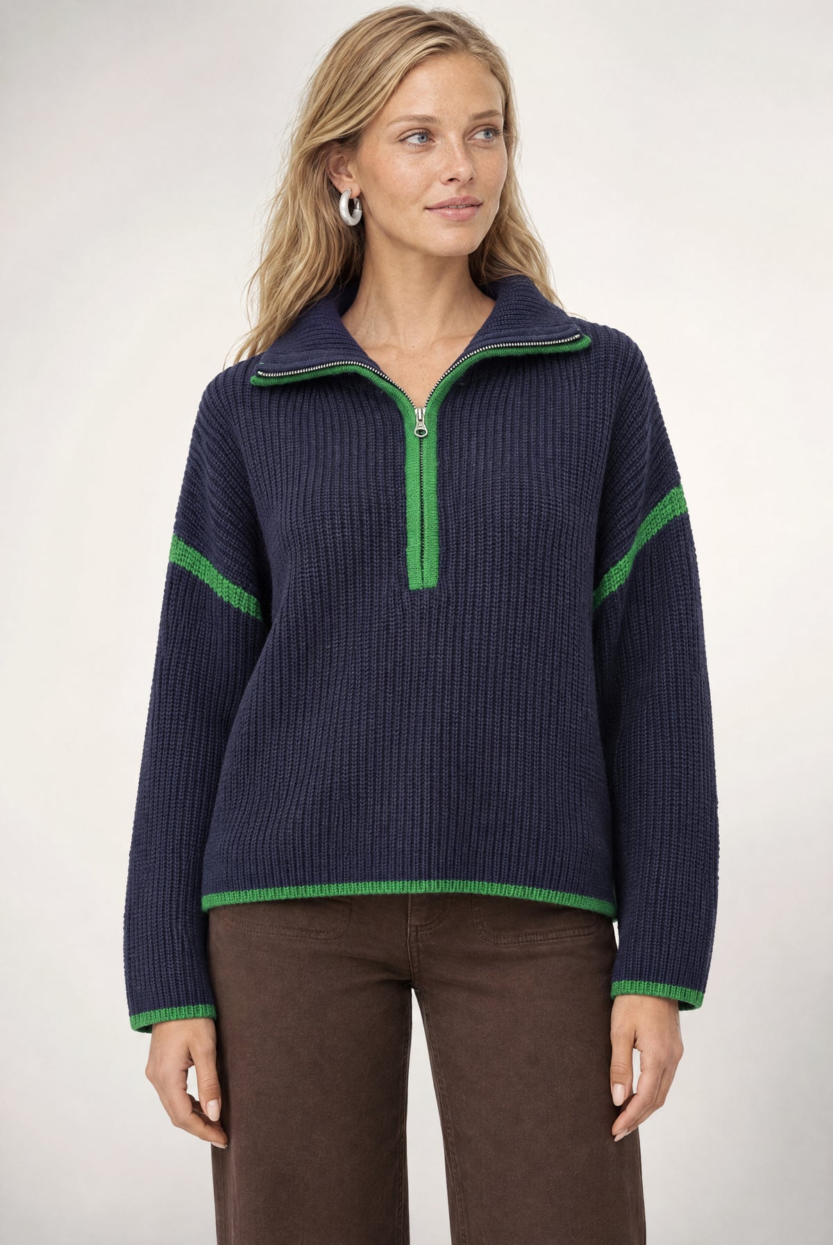 Navy ribbed half-zip sweater with green contrast trim on collar, sleeves, and hem.