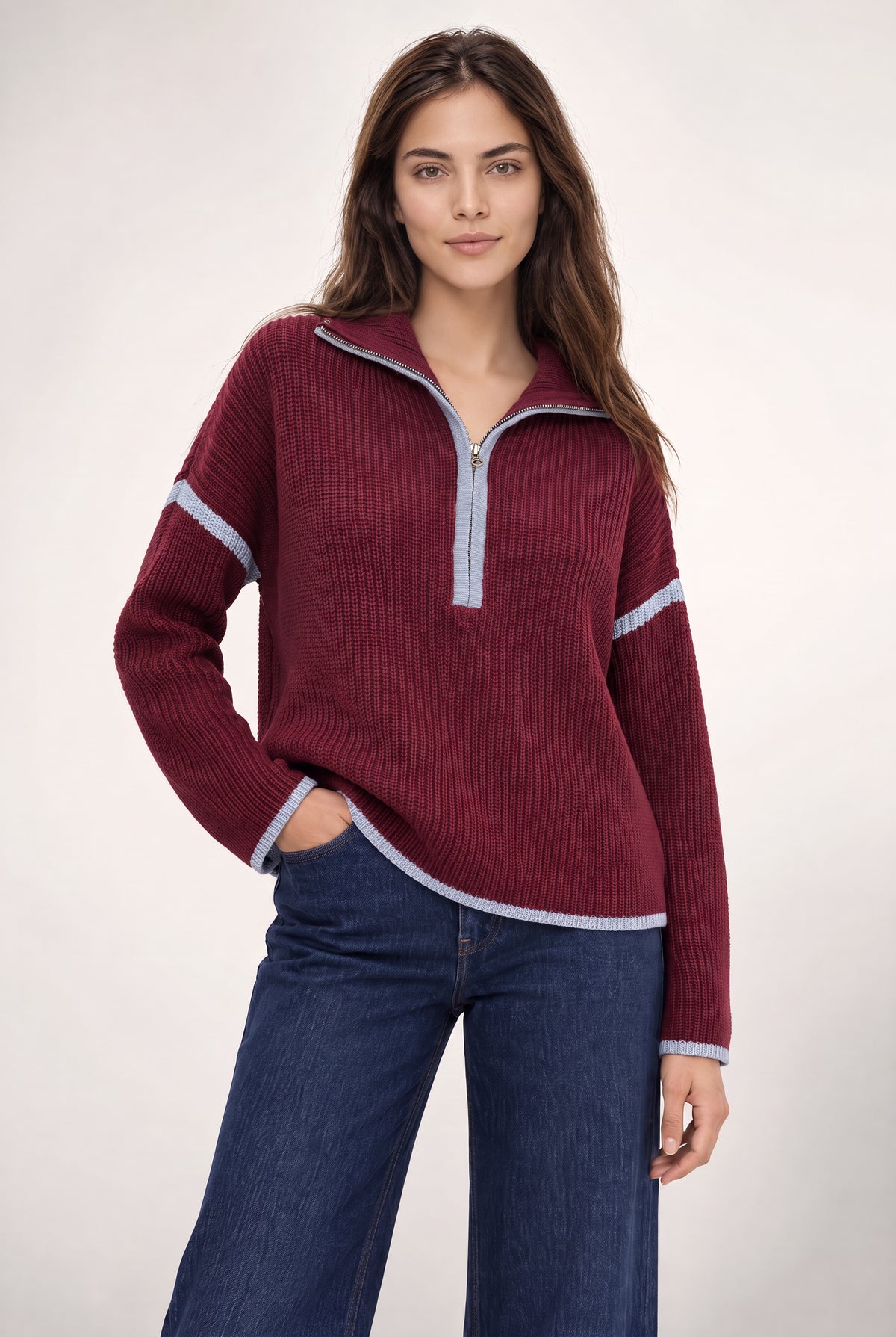 Burgundy ribbed half-zip sweater with light blue contrast trim on collar, sleeves, and hem.