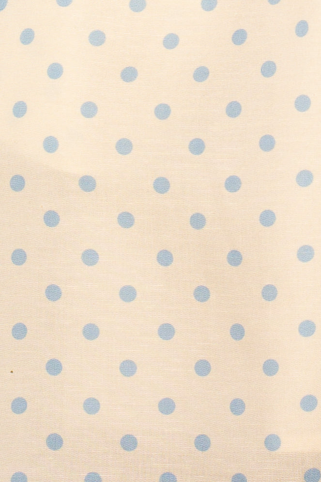 The Kita Tie Halter Mini Dress by Isla x Tate features cream fabric with a light blue polka dot pattern, perfect for a stylish mini dress look.
