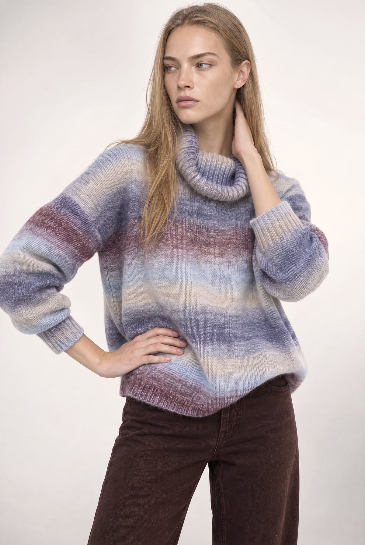 Striped turtleneck sweater in blue, purple, and cream with ribbed cuffs and hem.