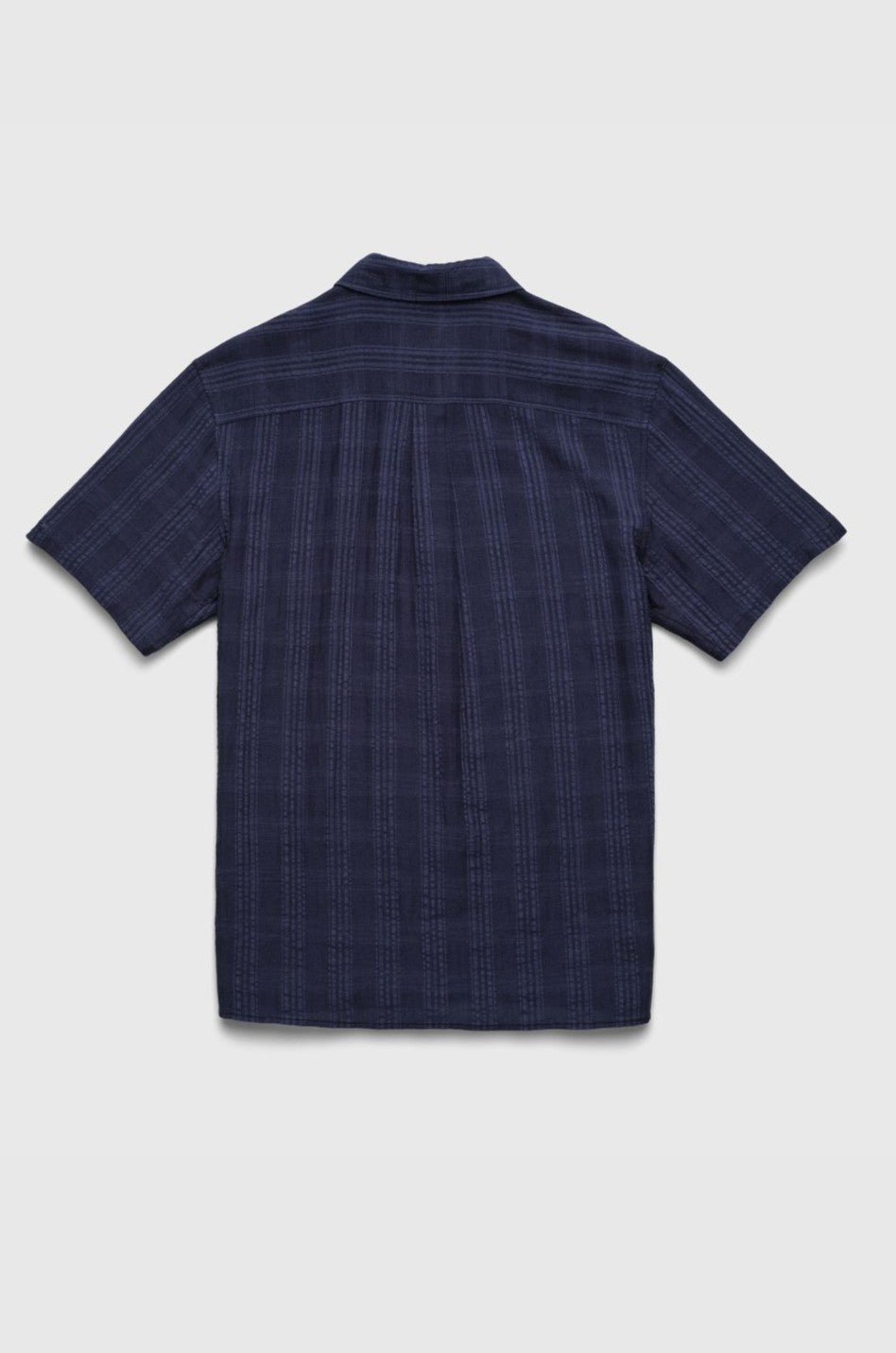 The Joseph Straight Bottom Textured Shirt by Surfside Supply Co. is a dark blue, short-sleeve button-up in cotton-rayon with a subtle plaid and textured finish, shown from the back on a light gray background.
