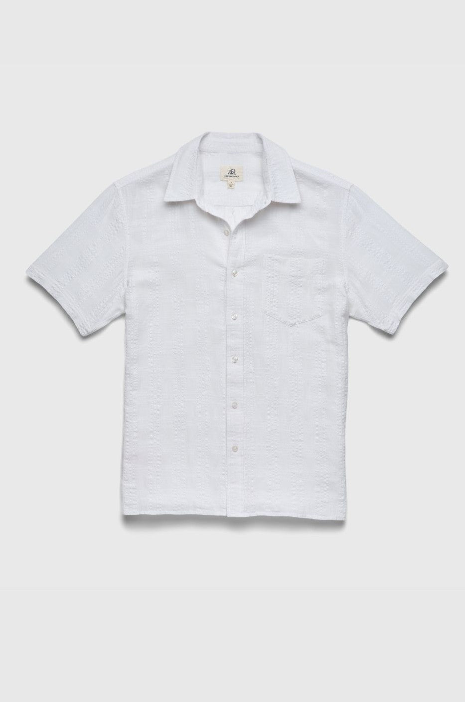 The Joseph Straight Bottom Textured Shirt by Surfside Supply Co. is a regular fit, short-sleeve white button-up with a subtle pattern, collar, and single chest pocket, shown on a plain light background.
