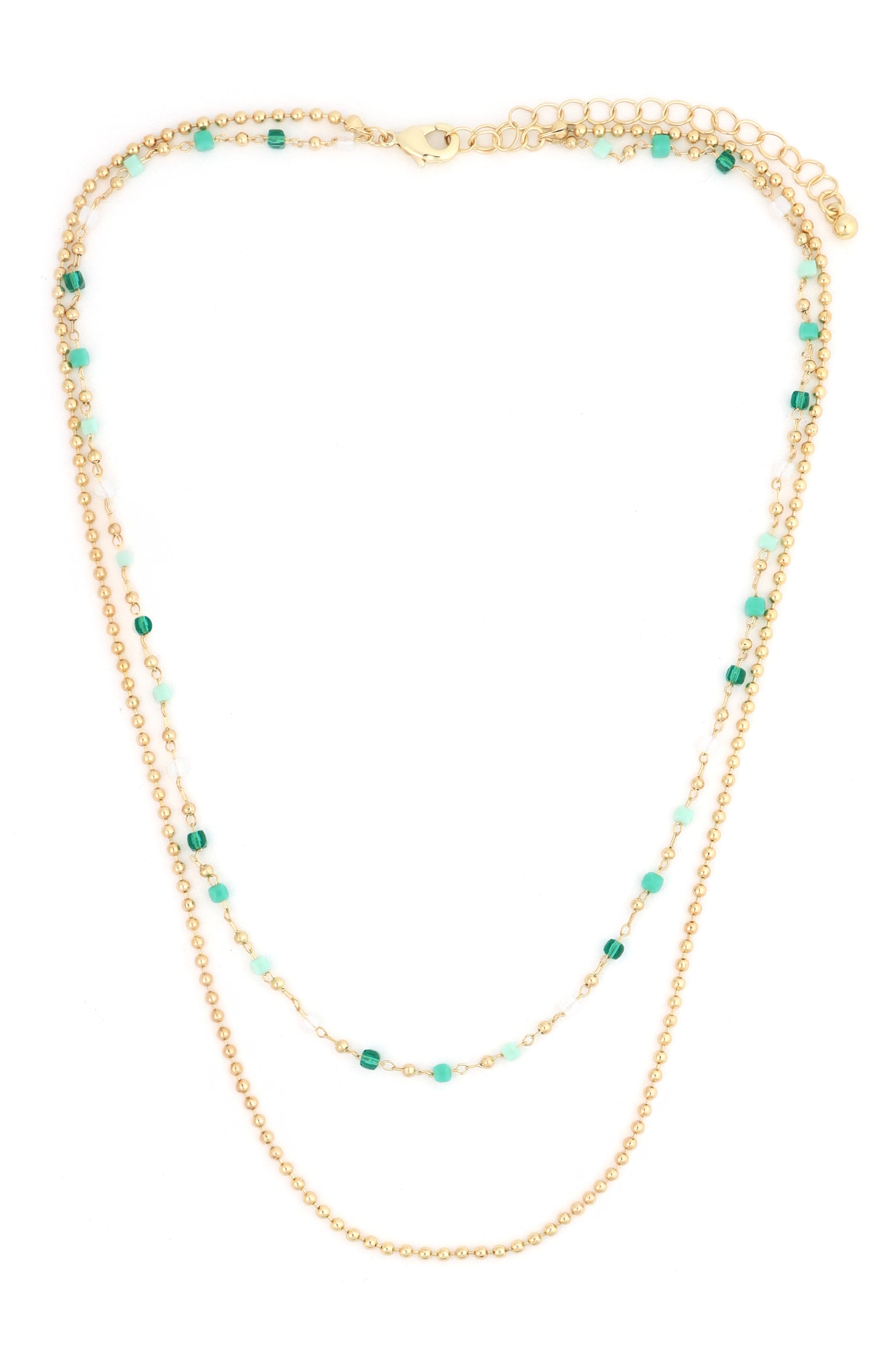 The South Moon Under Layered Beaded Chain Necklace features gold-plated brass, with one strand accented by turquoise and light blue glass crystal beads, and a second strand of plain gold beads, shown on a white background.