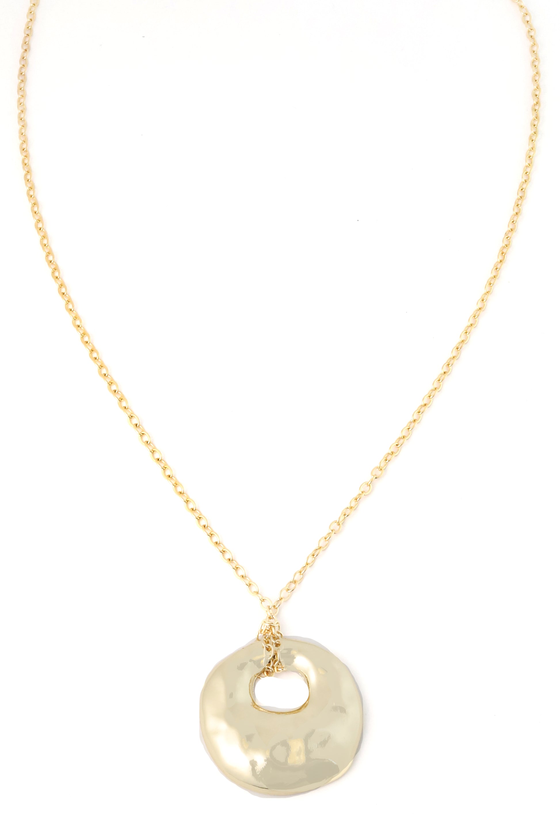 The South Moon Under Gold Hammered Pendant Necklace features a round, hammered gold pendant with an irregular cutout in the center, presented against a white background. This 28-inch gold necklace is finished with a secure lobster claw closure for easy wear.