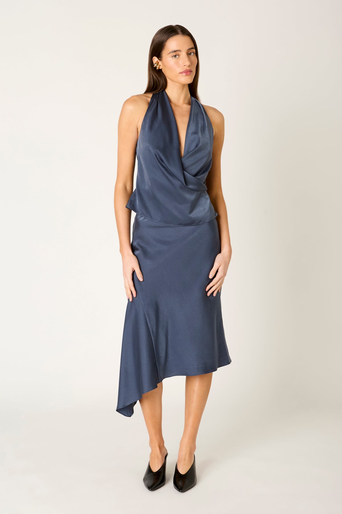 Navy halter top with draped neckline and asymmetrical hemline skirt.