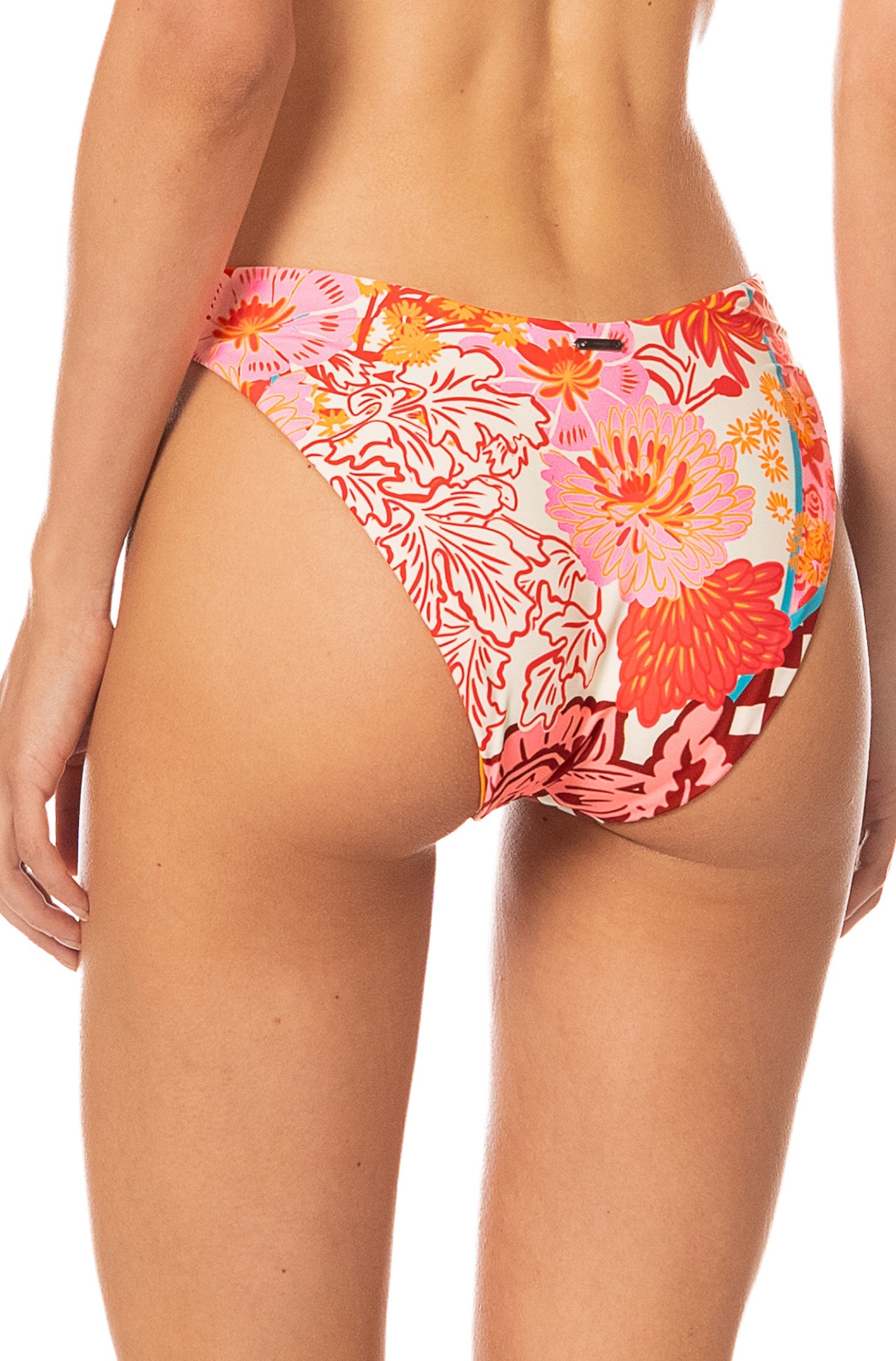 A person is shown from the back wearing Maaji’s Cosmic Tropic Splendour Bottom, a full-coverage bikini bottom with a floral print in orange, pink, and red tones, against a white background.
